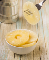 Canned pineapple rings. Ananas slices in a white bowl