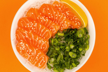 Hawaiian Poke Bowl Of Salmon Sashimi With Rice Noodles And Spring Onions
