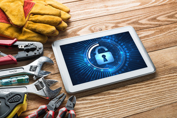 Web security and technology concept with tablet pc on wooden table