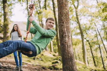 Teenagers Having fun on a Rope Swing