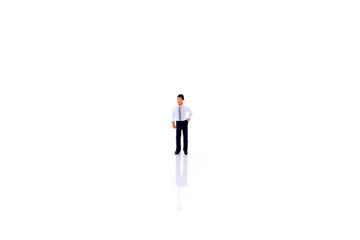 Miniature people : businessman standing on white background.