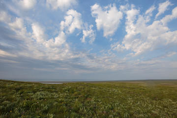 Fototapeta na wymiar The movement of clouds in the spring in the steppe part of the Crimea peninsula at Cape Opuk.