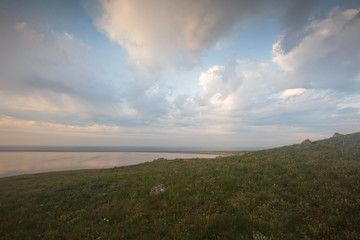 Fototapeta na wymiar The movement of clouds in the spring in the steppe part of the Crimea peninsula at Cape Opuk.