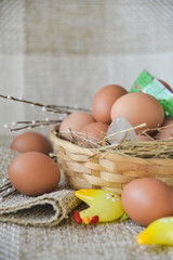 fresh farm chicken egg in the basket on textile background, preparation for Easter