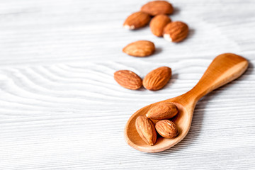 cosmetic almond oil in glass bottle on wooden background