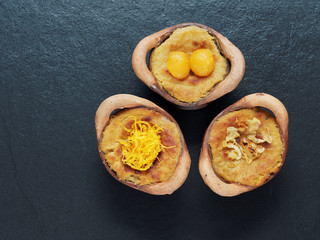 Thai coconut custard pudding dessert, Maw Gaeng, in clay pot on dark background