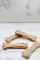 A dog's chew bones on a white board background. Pet care and veterinary concept