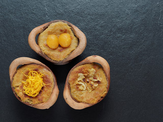 Thai coconut custard pudding dessert, Maw Gaeng, in clay pot on dark background