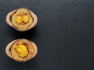 Thai coconut custard pudding dessert, Maw Gaeng, in clay pot on dark background