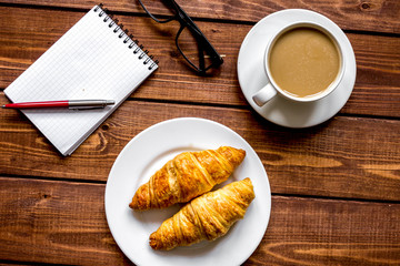 Business breakfast with coffee and croussant top view