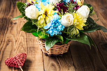 flowers with heart on a wooden background
