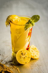 Limbo sharbat,lemon juice or Citrus × limon juice with some leaves of mint in a transparent glass.