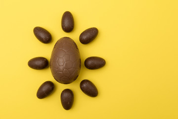 Fototapeta na wymiar Chocolate easter eggs on a bright yellow background. Easter holiday concept