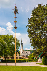 Traditional decorated maypole in alpine village St.Gilgen, Austria.Maypole is erected during folk festival on May 1