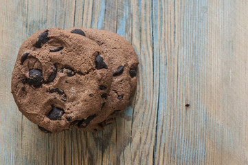 Chocolate cookies on wooden table.