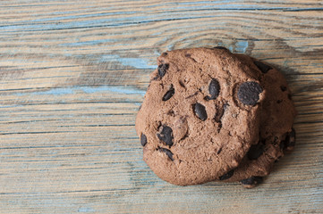 Chocolate cookies on wooden table.