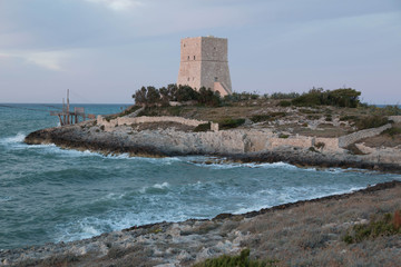 View of Vieste coast, Italy, with blue sea and an old defense tower.