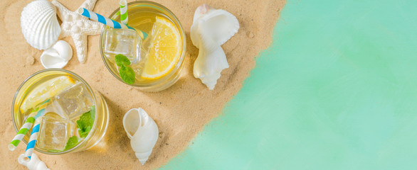 Fototapeta na wymiar Summer concept - sand, drinks, glasses, shells