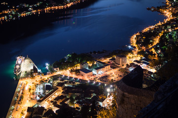 Fototapeta premium Port and Old Town of Kotor with Boats and Cruise Ship Seen from Lookout at Night, Montenegro