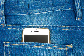 Mobile phone in the pocket of the blue jeans