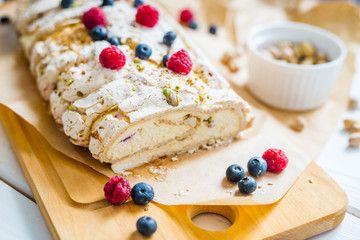 Homemade Meringue Almond Roll with Berries, Pistachios, Cream and Lemon Curd