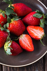 strawberry, brown plate, wooden background