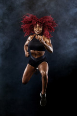 A strong athletic, female sprinter, running at sunrise wearing in the sportswear, fitness and sport motivation concept with copy space.