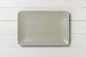 Blank rectangular plate on wooden background. top view