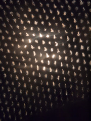 close up of holes fabric texture with light coming through