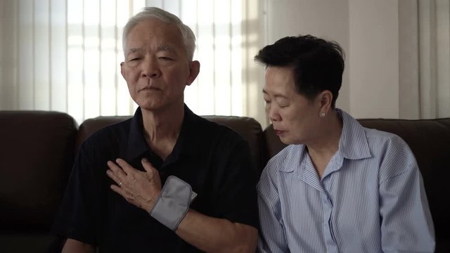 Asian senior couple health care do self blood pressure check
