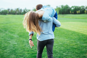 Pair of young people having fun on a green glade