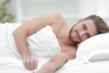 happy man, falling asleep in a comfortable bed