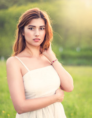 Young happy attractive woman posing in sunset