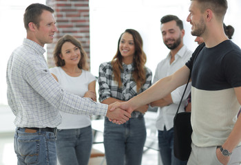 handshake business partners in the creative office.