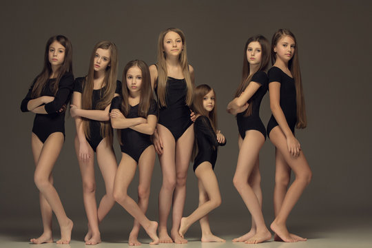 The group of teen girls posing at white studio