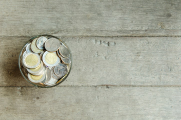 Thai money Coins in glass for saving money concept.