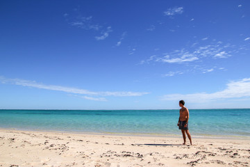 man looking to infinity on a beach