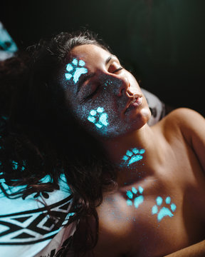 Woman with fluorescent tracks on face