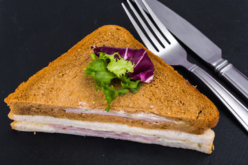 Sandwich with ham and cheese from wheat and rye bread