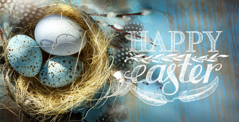 Happy Easter; Easter eggs  in basket on the blue table  background