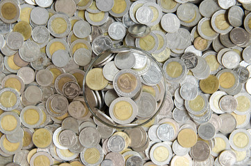Thai money Coins in glass for saving money concept.