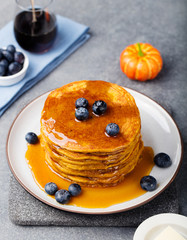 Pumpkin pancakes with maple syrup and blueberries