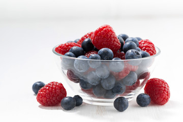fresh seasonal berries in a glass bowl, closeup