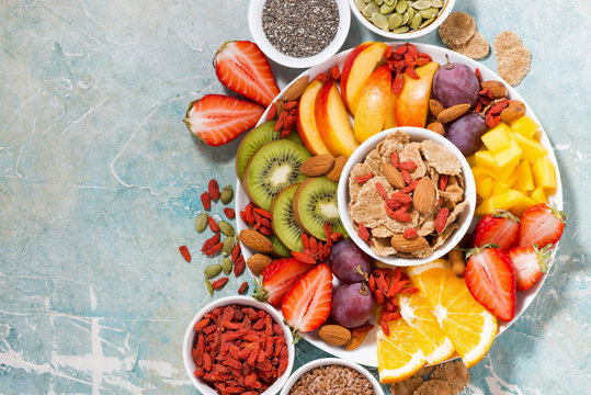 fresh seasonal fruits and superfoods and rustic background, top view
