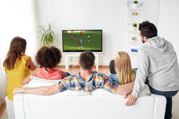 friends watching soccer game on tv at home