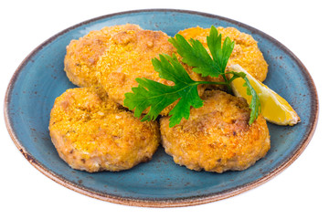 Fish cutlets on blue plate