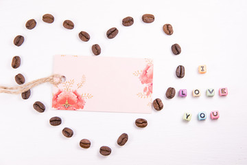 Heart of coffee beans on a white background with a business card in the middle and a place for the inscription and a signature I love you