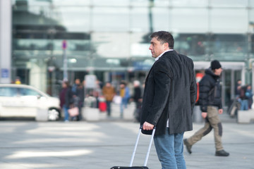 Portrait of traveler with luggage. Outdoors