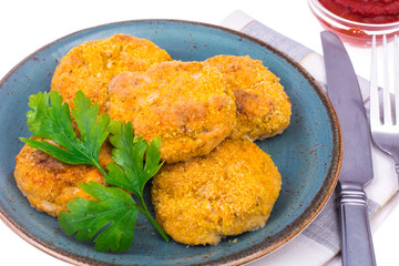 Fish cutlets on blue plate