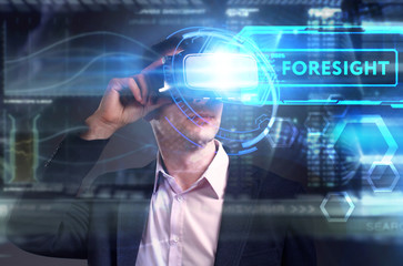 Business, Technology, Internet and network concept. Young businessman working on a virtual screen of the future and sees the inscription: Foresight